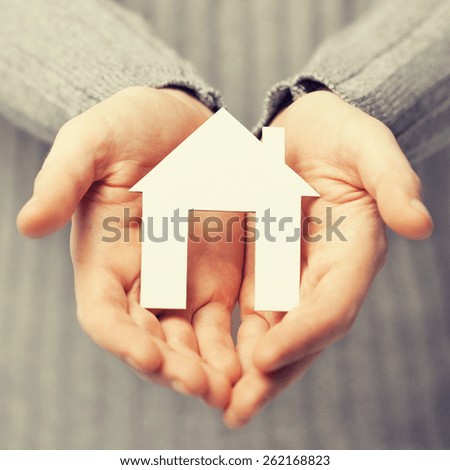bright picture of man holding paper house