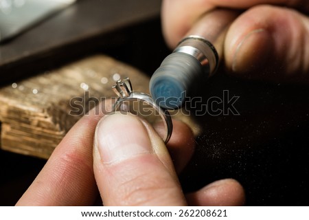 Craft jewelery making. Ring polishing. Macro shot. Royalty-Free Stock Photo #262208621