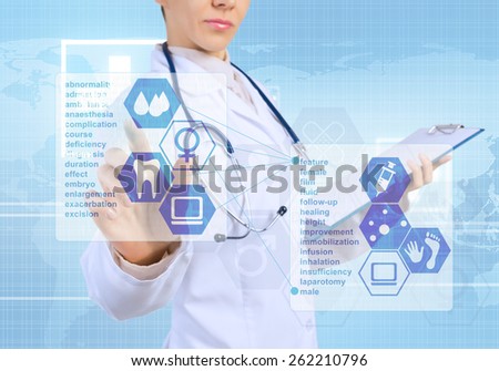 Young female doctor touching icon of media screen