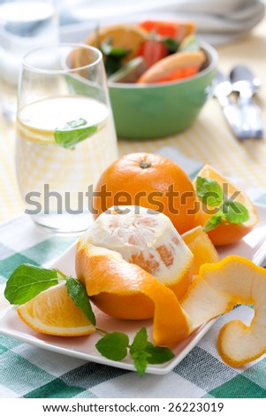 fresh oranges on white plate. shallow dof