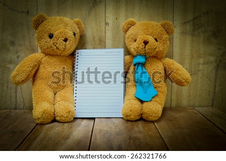 Two bears  on grunge wooden background.