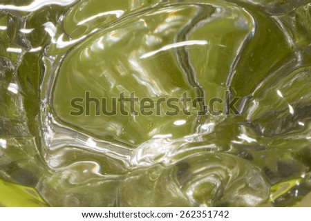 Background of water ripples in a glass with green background 