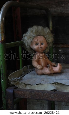 pour childhood, old dirty doll sitting on the old bed