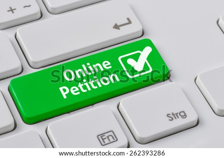 A keyboard with a green button - Online Petition Royalty-Free Stock Photo #262393286