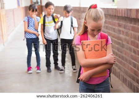 Pupils friends teasing a pupil alone in elementary school Royalty-Free Stock Photo #262406261
