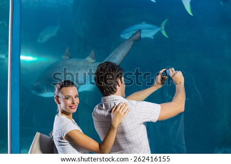 Couple taking photo of shark at the aquarium