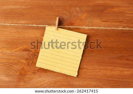 love note on the pin on wooden background