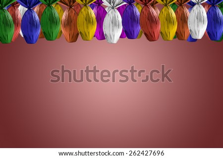 Brazilian Easters eggs hanging, on a red background.
