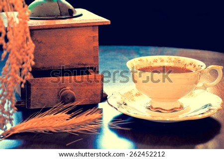 Food and drinks conceptual image. Antique porcelain cup of decaffeinated coffee on the table. Dark retro vintage picture.