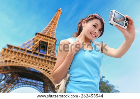 Happy travel woman in Paris with Eiffel Tower and she take a selfie picture, asian beauty Royalty-Free Stock Photo #262453544