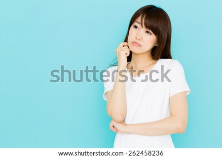 attractive asian nurse on blue background