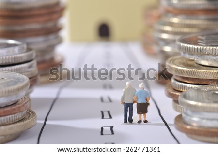 Couple of elderly walking the road surrounded by money Royalty-Free Stock Photo #262471361