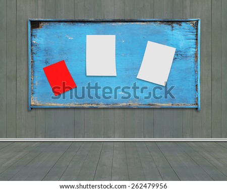Three blank papers posted on old blue weathered noticeboard with dark green wood wall and floor background. Marked with your own message.