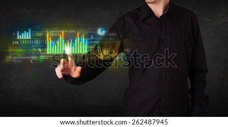 Business person touching colorful charts and diagrams