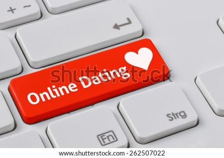A keyboard with a red button - Online Dating
