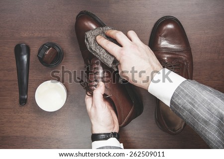 Formal business men leather shoes shining Royalty-Free Stock Photo #262509011