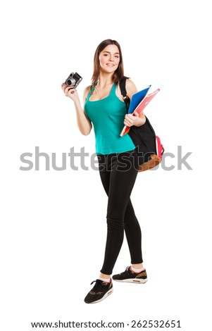 Beautiful young female student posing with notebooks and camera