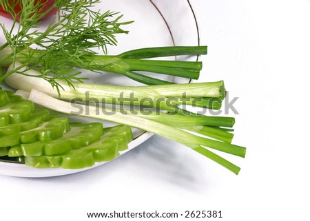 spring onion, dill and bitter lemon on the white dish