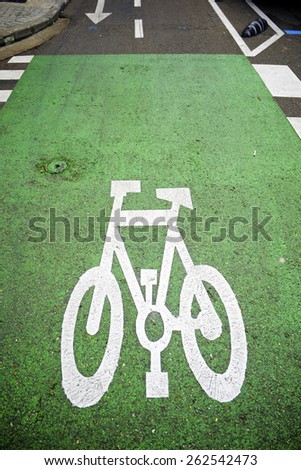 Bike lane sign painted on a street.