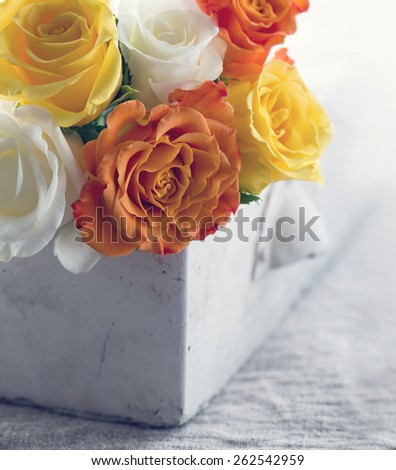Bouquet of yellow and orange roses with hazy vintage editing