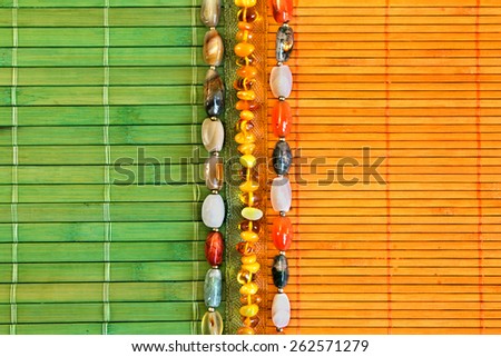 background with female ornaments on a bamboo mat