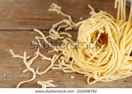 Homemade vermicelli on wooden background