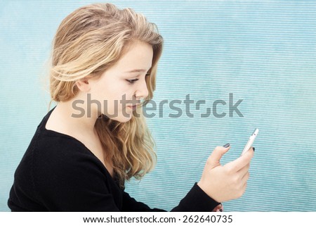 Girl with cellphone selfie or texting an sms