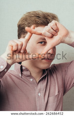 man making frame hands and looking into it