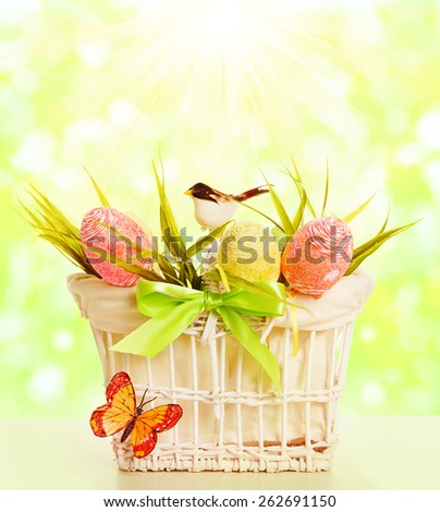 Easter Basket Eggs, Spring Objects Decorated by Grass Bird Butterfly over Green Unfocused Sunny Sky Background