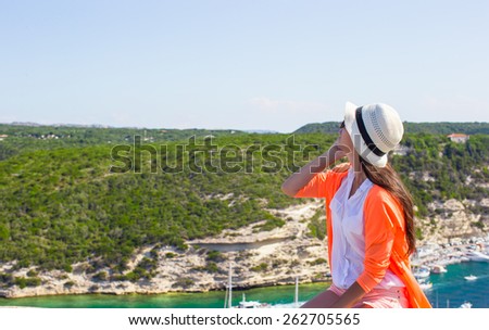 Young happy woman outdoors with beautiful view in Bonifacio city, Corsica