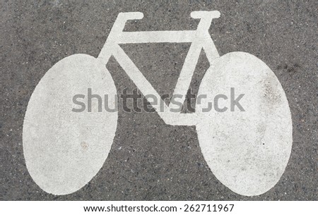 White bicycle sign on concrete street