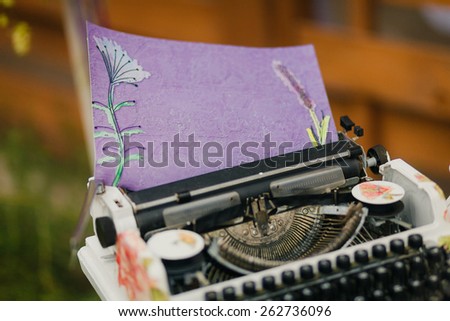 Vintage typewriter with fancy violet paper in it