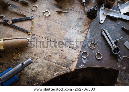 Working desk for craft jewelery making with professional tools. Grunge wooden table. View from above. Copy space. Royalty-Free Stock Photo #262736303