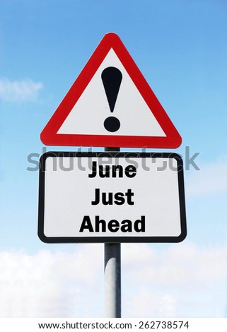 Red and white triangular warning road sign informing that June is Just Ahead concept against a partly cloudy sky background