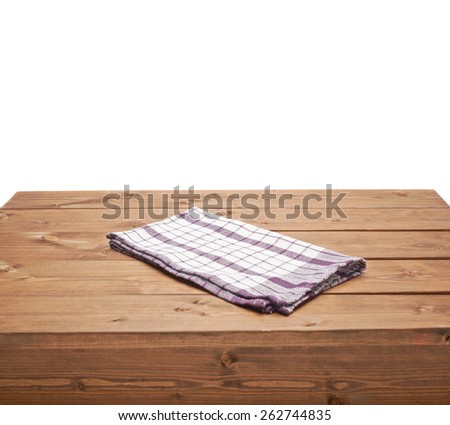 Violet tablecloth or towel over the surface of a brown wooden table, composition isolated over the white background