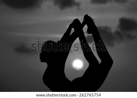 High quality, high resolution, professional yoga woman silhouette at sunset.
