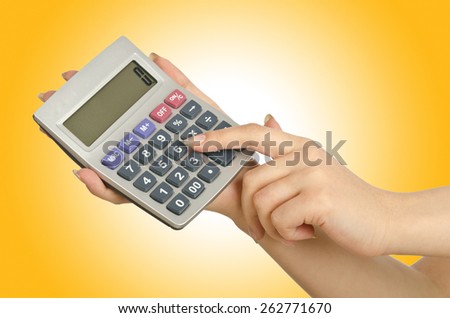 Hand holding calculator on white