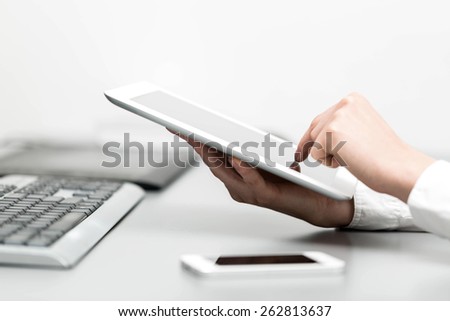 close up hands multitasking woman using tablet, laptop and cellphone connecting wifi in office Royalty-Free Stock Photo #262813637
