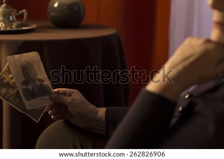 Close-up of grandmother looking at grandson picture