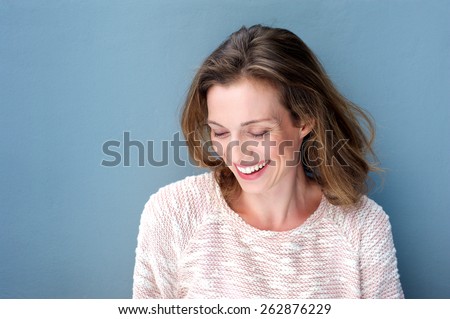 Close up portrait of a beautiful mid adult woman laughing with sweater Royalty-Free Stock Photo #262876229