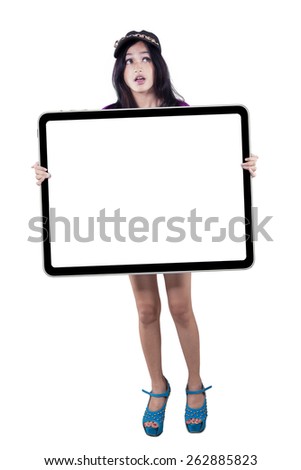 Portrait of young asian teenage girl standing in the studio while holding an empty signboard