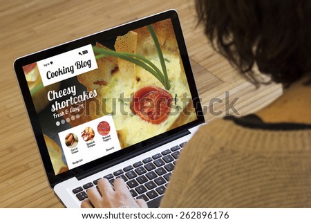 cooking recipes online: cooking blog on a laptop screen Royalty-Free Stock Photo #262896176