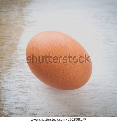 Healthy food brown chicken egg on white wood table background