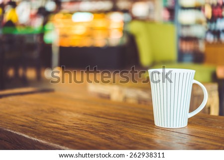 Hot latte Coffee cup on wooden table in coffee shop - vintage effect style pictures