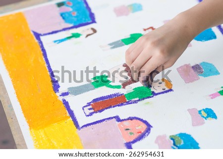 Child hand drawing with crayon