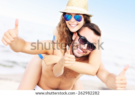 A picture of a young couple having fun at the beach in the summer