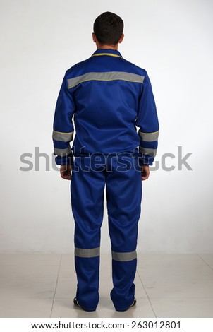 A man in overalls and work wear.Isolated studio portarit