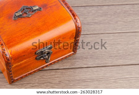 Wooden chest with metallic trim on background 