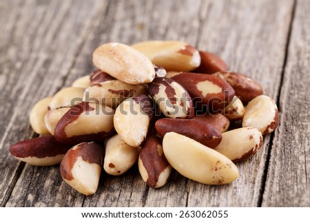 Some brazil nuts on a wooden background.