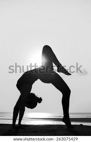 High quality, high resolution, professional yoga woman silhouette at sunset.